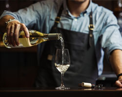 Bartender pouring wine